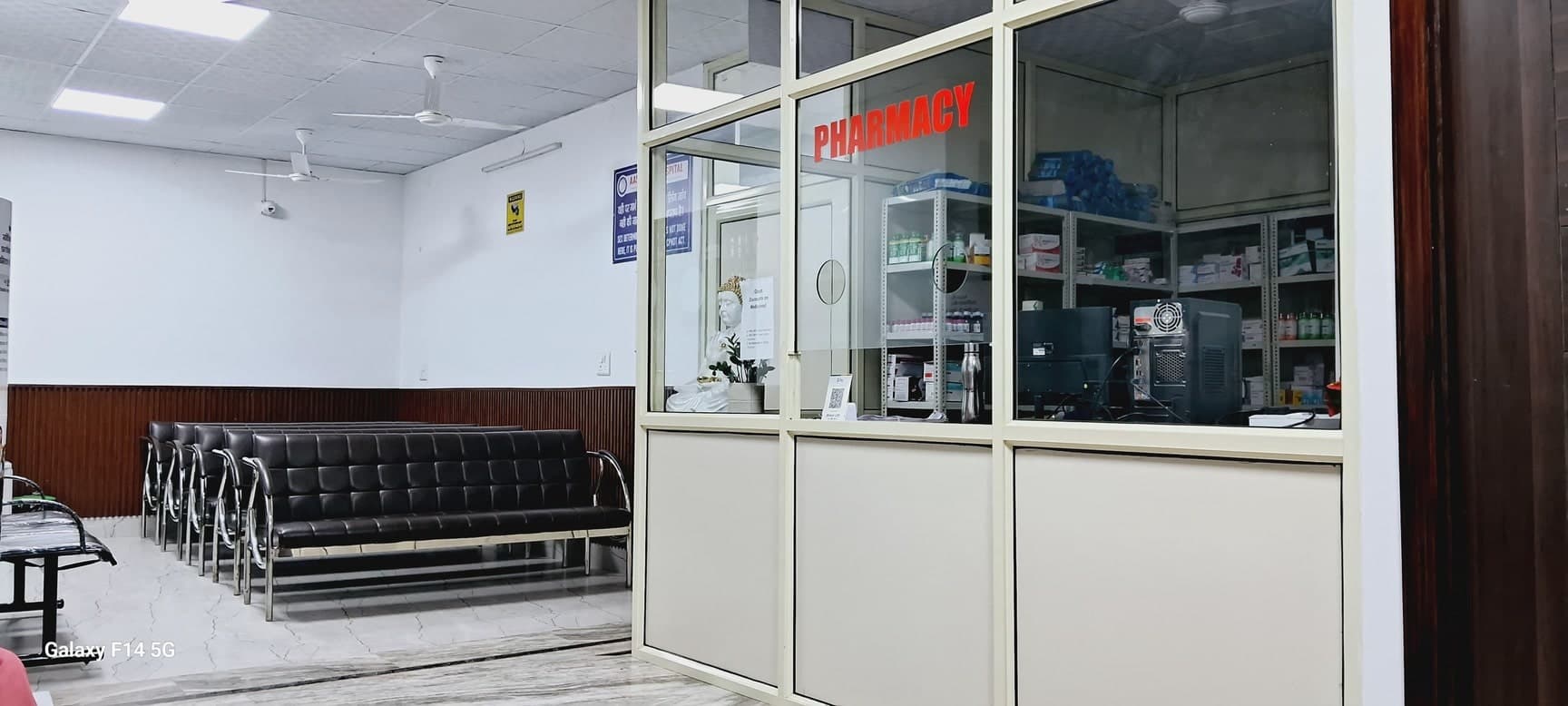 Aashirwad Hospital pharmacy counter and waiting area with seating