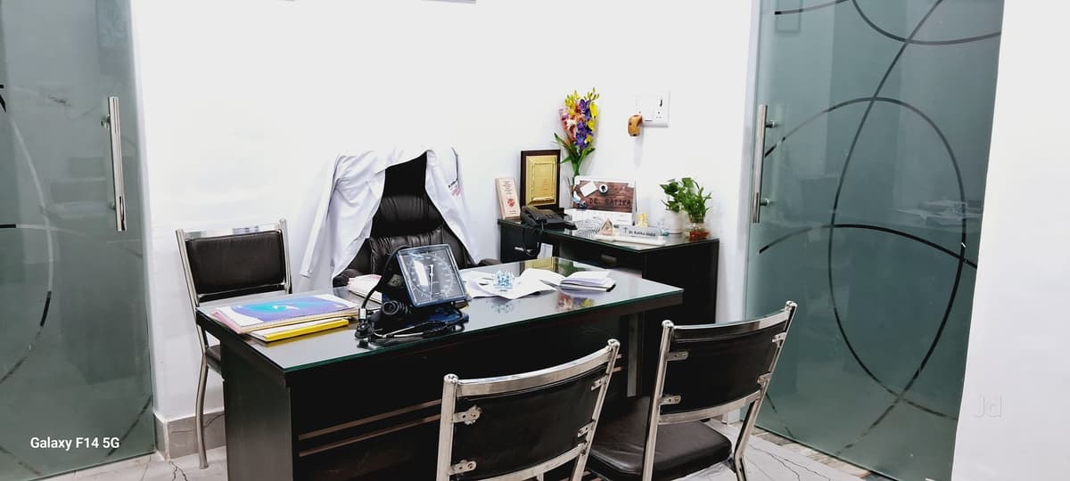 Dr. Ratika Jindal consultation cabin with desk and medical equipment