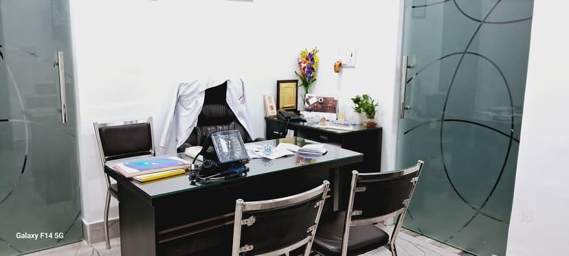 Doctor Ratika Jindal consultation room with desk and medical equipment